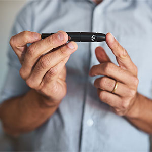 man checking his blood sugar